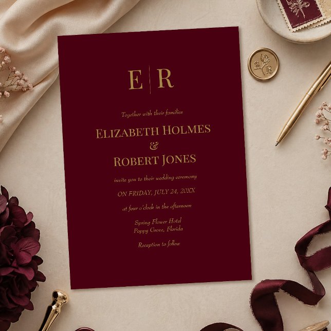 Faire invitation de mariage à monogramme doré et b (Elegant Burgundy Gold Monogram Wedding Invitation on a table with burgundy wedding decoration)