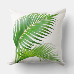 Feuilles tropicaux vert palmier sur oreiller blanc