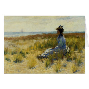 Fille assise au bord de la mer