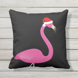 Flamant rose de Père Noël sur le coussin extérieur