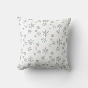 Flocons de neige sur un coussin blanc jeté