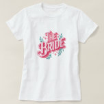 Floral The Bride Calligraphy T-Shirt for Wedding<br><div class="desc">Embrace the joy of your upcoming nuptials with our Floral 'The Bride' Calligraphy T-Shirt. Designed for the modern bride who loves a blend of contemporary style and botanical charm, this shirt features elegant calligraphy enveloped by a wreath of lush greenery and soft pink accents. Perfect for bridal showers, bachelorette parties,...</div>