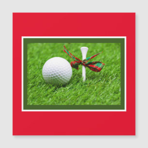 Golf balle Noël avec tee sur herbe verte