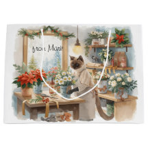 Chat arrangeant des fleurs d'hiver pour Noël 