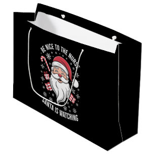Grand Sac Cadeau Soyez gentil avec l'infirmière, le Père Noël regar