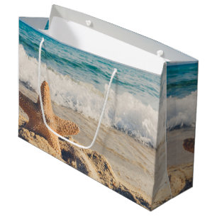 Grand Sac Cadeau Starfish sur une plage de sable Photo