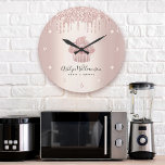 Grande Horloge Ronde Bakery Cupcake Pastry Chef Rose Gold Glitter Drips<br><div class="desc">Make a stylish impression with this elegant, sophisticated, simple, and modern custom name wall clock. A sparkly, rose gold cupcake, script handwritten typography and glitter drips overlay a faux metallic rose gold ombre background. Personalize with your full name, business, or other info. Your choice of a round or square clock...</div>