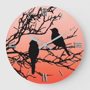 Grande Horloge Ronde Oiseaux sur une branche, noire contre l'orange de