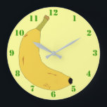 GRANDE HORLOGE RONDE YELLOW BANANA IN POP ART STYLE WITH GREEN NUMBERS<br><div class="desc">A light yellow clock with green numbers,  et a digital illustration of a tropical banana. Available in other options. Visit our store for more Wall Clocks and other Home Toxits.</div>