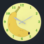 GRANDE HORLOGE RONDE YELLOW BANANA IN POP ART STYLE WITH GREEN NUMBERS<br><div class="desc">A light yellow clock with green numbers,  et a digital illustration of a tropical banana. Available in other options. Visit our store for more Wall Clocks and other Home Toxits.</div>