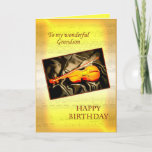 Grandson, une carte d'anniversaire musicale avec u<br><div class="desc">Une carte musicale avec un violon allongé sur la soie. Dans l'arrière - plan est une page de partitions. Voir toute la gamme de cartes pour les âges et les relations dans mon magasin. Toutes les oeuvres d'art copyright Norma Cornes</div>