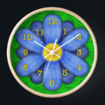 Horloge Blue Daisy Flower on Green Beautiful<br><div class="desc">This pretty floral clock has sur stylized flower on it, in a daisy style and colored blue. The yellow-orange clock numbers mark the time on the twelve petals. The background is done in abstract mottled green, resembling grass. This is a bright, bold clock for a gardener or any lover of...</div>