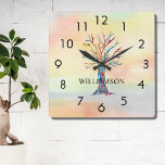 Horloge Carrée Arbre arc-en-ciel personnalisé<br><div class="desc">Cette horloge murale colorée est décorée d'un arbre généalogique en mosaïque aux couleurs de l'arc-en-ciel sur un arrière - plan d'aquarelle. Facilement personnalisable avec votre nom. Parce que nous créons notre propre oeuvre,  vous ne trouverez pas cette image exacte d'autres designers. Mosaïque originale et aquarelle © Michele Davies.</div>