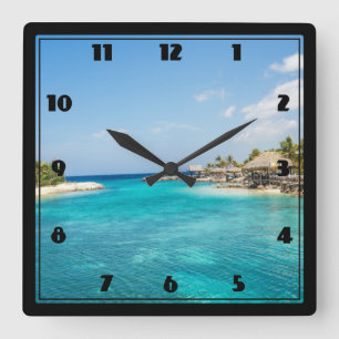 Horloge Carrée Belle plage tropicale Bleue aux huttes de chaume