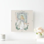Horloge Carrée Galadriel Light of Valinor Graphic<br><div class="desc">Step into the radiant grace of Middle-Earth™ with this exquisite Lord of the Rings™ design inspired by Galadriel™. Illustrated in an elegant, Art Nouveau–inspired style, she stands poised and luminous, holding a phial of the Light of Valinor with serene strength and quiet authority. Flowing golden hair, delicate Elven adornments, and...</div>