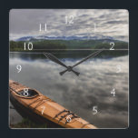 Horloge Carrée Kayak en bois sur la rive du lac Beaver<br><div class="desc">Chuck Haney / DanitaDelimont.com | USA,  Amérique du Nord,  Montana | Kayak en bois sur la rive du lac Beaver près de Whitefish,  Montana,  USA.</div>