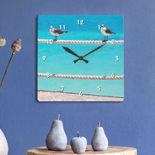 Horloge Carrée Oiseaux blancs de mouette sur corde bleu turquoise