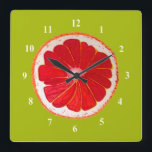 Horloge Carrée Pop art pamplemousse rose art original aquarelle<br><div class="desc">Une jolie tranche de pamplemousse rose très colorée d'un tableau original de l'artiste Sacha Grossel. Ce grand fruit de style pop art est rose et très lumineux et coloré contre un arrière - plan personnalisable couleur vert citron. Excentrique et original.</div>