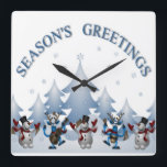 HORLOGE CARRÉE SEASONS GREETINGS<br><div class="desc">"SEASONS GREETINGS" WITH SNOW COVERED CHRISTMAS TREES ,  SNOWMEN AND REINDEER</div>