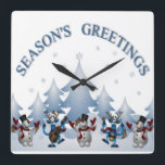 HORLOGE CARRÉE SEASONS GREETINGS<br><div class="desc">"SEASONS GREETINGS" WITH SNOW COVERED CHRISTMAS TREES ,  SNOWMEN AND REINDEER</div>