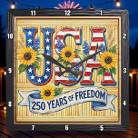 Horloge Carrée USA 250 Years Freedom Sunflower<br><div class="desc">Celebrate a historic quarter-millennium with the "250 Years of Freedom" Sunflower clock. This high-energy timepiece features a high-definition graphic that blends patriotic pride with natural beauty. The design centers on bold, stylized "USA" lettering filled with stars and stripes, prominently accented by vibrant, sun-drenched sunflowers and blue wildflowers. A graceful white...</div>