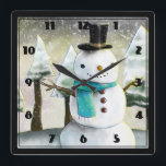 Horloge Carrée Whimsical Snowman Winter Scene Christmas Drawing<br><div class="desc">Clock with a cute drawing featuring a snowman wearing a cool and scarf. The background has a line of whimsical snow-covered pine trees.</div>