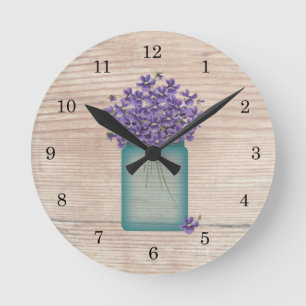 Horloge murale bleue de violettes de pot de maçon