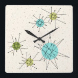 Horloge murale Carré de Starbursts atomique Iconiq<br><div class="desc">Ce motif de Carré de Starbursts Atomique (en gros caractères) acrylique de Starbursts propose des étoiles atomiques emblématiques. C'est vrai ! L'ancienne école, arrière - plan crème avec des taches d'or est la toile de fond parfaite pour le céleri turquoise, apaisant, et les cercles kitsch vert poire. Les taches de...</div>