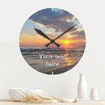 Horloge murale personnalisée photo et texte person<br><div class="desc">Téléchargez une photo, ajoutez du texte et créez facilement votre horloge murale photo personnalisée. Cliquez sur PERSONNALISER pour modifier la couleur du texte. Vous pouvez TRANSFÉRER ce DESIGN sur d'autres produits Zazzle et l'ajuster à la plupart des articles Zazzle. Les conceptions Studio standard sont faites dans des graphiques vectoriels haute...</div>