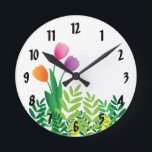 Horloge Ronde Colorful Tulips and Green Vegetation<br><div class="desc">This clock features a fresh spring design with orange,  pink and purple tulips and green vegetation. The clock is perfect for adding that "spring look" to your home and also would make a great Mother’s Day gift.</div>