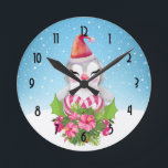 Horloge Ronde Cute Christmas Penguin in Santa Hat<br><div class="desc">A clock with a cute and whimisical design featuring an adorable penguin wearing a red santa hat. Standing behind a bouquet of flowers with pink and white striped candy canes. A snowy winter background with snowflakes falling.</div>