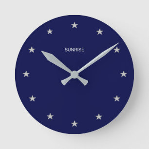 Horloge Ronde Élégantes étoiles de lever de soleil sur fond bleu