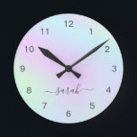 Horloge Ronde Girly Modern Elegant Script Nom Holographique<br><div class="desc">Horloge murale moderne avec votre nom dans un élégant script manuscrit avec des swashes sur un dégradé holographique coloré en rose pastel,  violet,  bleu et vert. Cette horloge murale design et féminine est idéale pour une fille et fait un grand cadeau pour elle.</div>