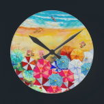 Horloge Ronde Parapluies<br><div class="desc">Vagues sur une plage de sable,  bains de soleil sous des parasols colorés,  cette horloge est un ajout amusant à votre maison de plage ou décor d'été ou offrir en cadeau. CORRESPONDRE des articles dans notre magasin.</div>