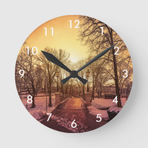 Horloge Ronde Vue panoramique du parc enneigé au coucher du sole