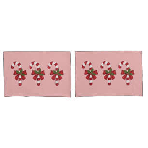 Housse D'oreillers Trois cannes de bonbon de Noël sur fond rose clair