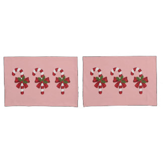 Housse D'oreillers Trois cannes de bonbon de Noël sur fond rose clair