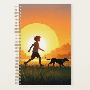 Jeune garçon avec chien au coucher du soleil