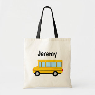 Joli bus scolaire jaune tirant le sac fourre-tout