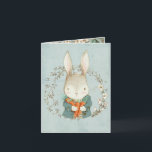 Joli lapin aux carottes Carte Pâques<br><div class="desc">L'avant de cette carte présente un mignon lapin tiré à la main portant un manteau bleu et tenant une poignée de carottes orange vif. Il est entouré d'une couronne de printemps. L'arrière - plan est une couleur bleu oeuf de robin en détresse. L'intérieur a de belles fleurs printanières encadrant l'intérieur...</div>