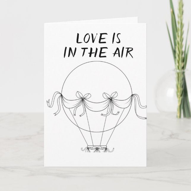 **L'AMOUR** EST EN L'AIR **SUR NOTRE CARTE ANNIVER (Devant)