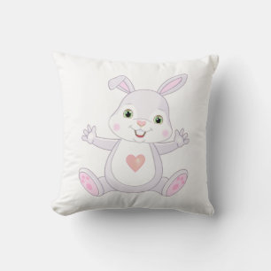 Lapin bébé mignon sur un coussin blanc