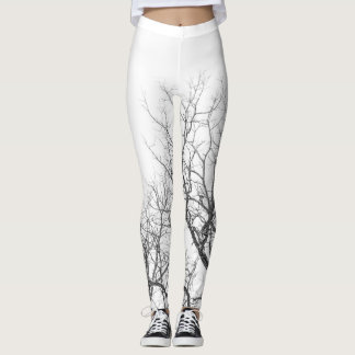 Leggings Légendes blanches avec branches d'arbres.