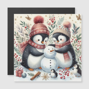 Manchots construisant un bonhomme de neige