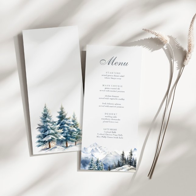 Menu Mariage des monts et pins de neige (Snowy Mountain & Pine Trees Wedding Menu on a sunny white table.)