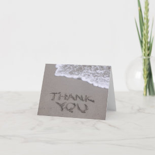Merci écrit dans la carte de note de sable