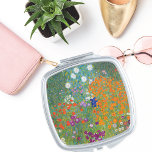 Miroir De Poche Paysage floral Gustav Klimt<br><div class="desc">Un miroir compact avec le tableau Art nouveau de Gustav Klimt (1862-1918),  Jardin aux fleurs (vers 1906). Un jardin rempli de pétunias colorés,  de masques et autres fleurs.</div>