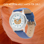 Montre Chat Occidental Et Nom Turquoise<br><div class="desc">Cette jolie montre à poignet conçue par un chat occidental est pour les enfants. Le design a été inspiré par les vieux tapis tissés du Rio Grande d'Amérique autochtone. Les couleurs de la terre comprennent l'ocre, le marron, le turquoise et l'argile rouge. Ces yeux turquoises s'écorchent d'un visage de montre...</div>
