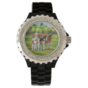 Montre Vache de Guernesey et veau mignon dans les pâturag