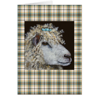 moutons avec la carte de nid sur le plaid